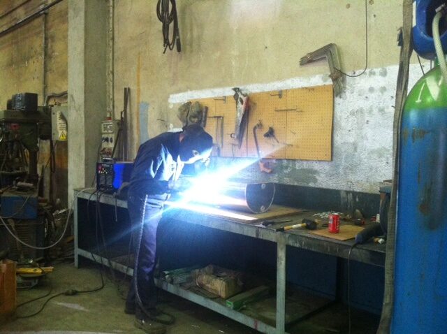 Welder at workshop bench